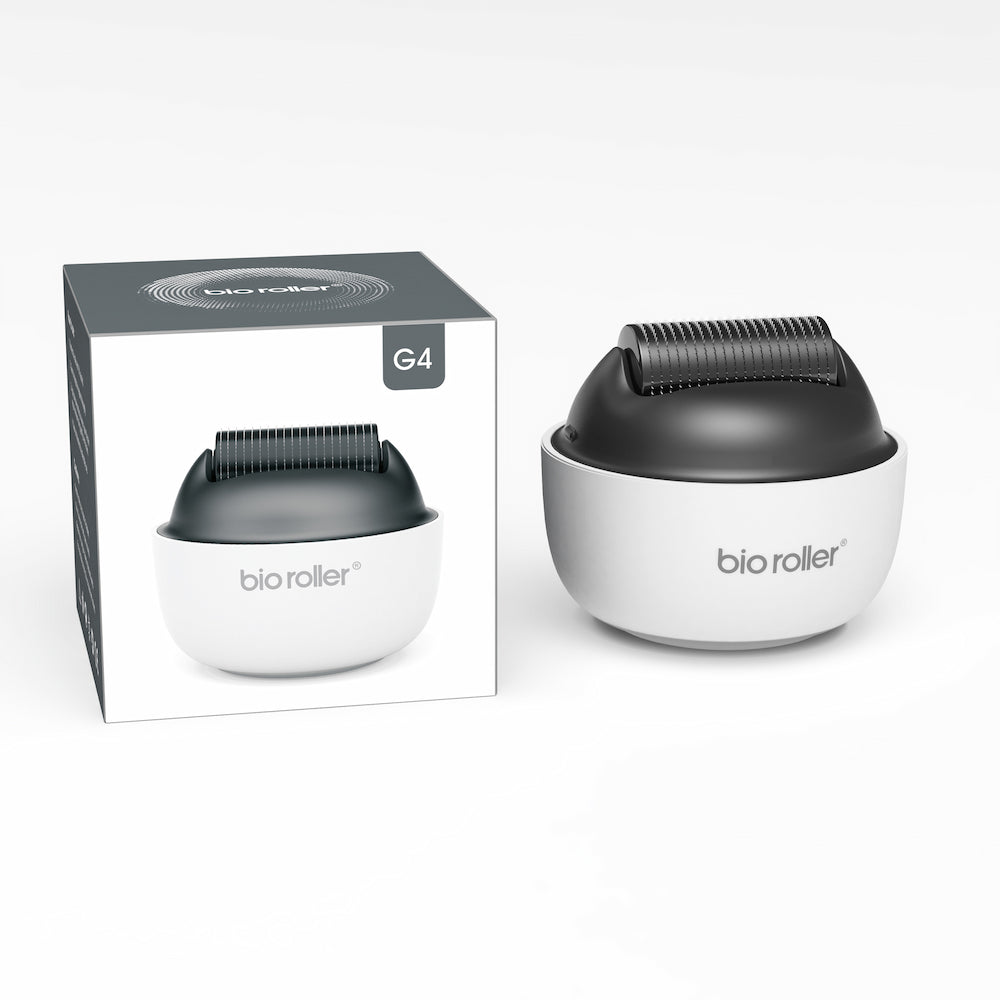 Bio Roller G4 microneedling-rulle sammen med produktpakken, designet til ansigtsbehandling, hudforyngelse og forbedret serumabsorption.